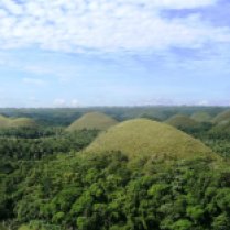 CHOCOLATE HILLS - Located at Carmen, Bohol, Philippines. There are about 1,200 of them scattered on a vast are. Famous, picturesque and majestic. By summertime the green scenery dies making the hills colored brown, hence its name. Once up on the the hill, there is still an elevated area where you have to walk to the top to get a clear view of the vicinity. On the hill is a hotel and the cost per night of stay is approximately around PHP1,200.00. A restaurant is also nearby that caters local delicacies. For those who do not have personal vehicles, there are motorcycles at the entrance for rent at PHP20.00 per person per trip. The need to take a ride is a must as you will be going up a hill. You can also request them to fetch you back at the designated time. They can also take you to places of interest for a fee. MY PERSONAL ADVISORY: Sleep at Chocolate Hills Hotel and enjoy watching the sunset as it unfolds and wake up early and enjoy watching a breathtaking sunrise. (UPDATE : OCTOBER 15, 2013 - Viewing deck of the Chocolate Hills partially damaged due to 7.1 maginitude earthquake.)